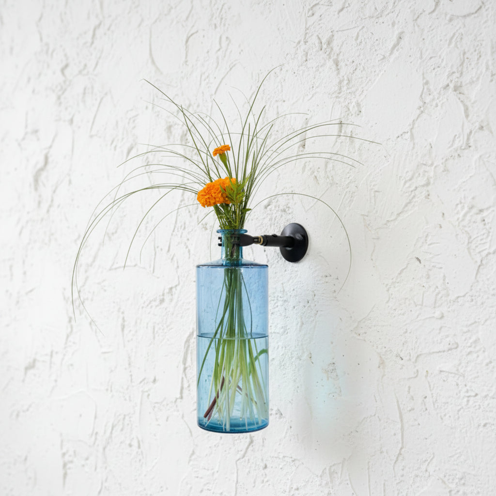 Blue vase  with flowers mounted on wall using Curator Wall mount and clamp